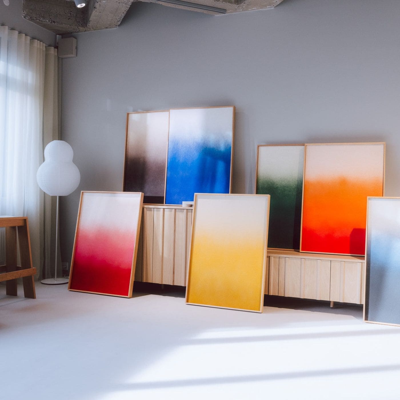 Colorful acoustic artworks leaning against a wall, showcasing modern interpretations of graffiti art for walls.